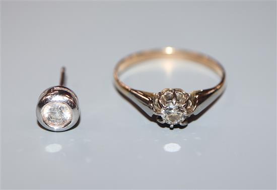 A yellow metal and solitaire diamond ring and a diamond set ear stud.